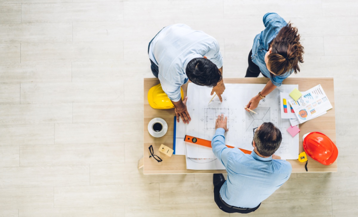 Team reviewing plans and site drawings together at a table
